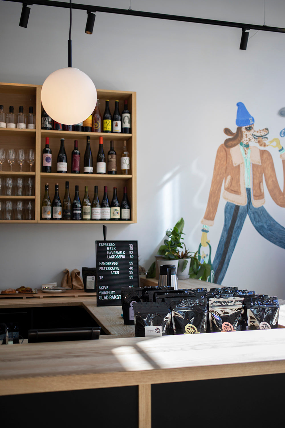Dapper's Nordre gate coffee bar: mural painted on the wall by artist Charlie Roberts, bags of coffee for sale from Tim Wendelboe. Bright and sunny with nice light and lots of space. 