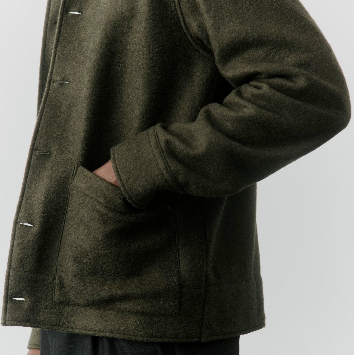 Close-up of an overshirt with hand in pocket.