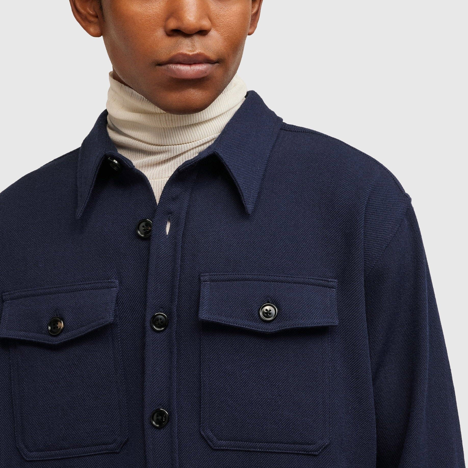 Close-up of a man wearing an overshirt.